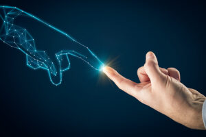 "Illustration of a human hand reaching out to touch a digital hand composed of glowing blue lines and nodes, symbolizing the connection between human intelligence and artificial intelligence for enhanced productivity and innovation."